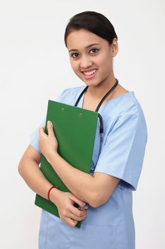 nurse doctor woman smile with stethoscope hold clipboard, wear blue surgery medical suit. Isolated over white background

