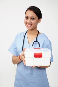 female nurse or doctor carrying a portable first aid kit isolated on white