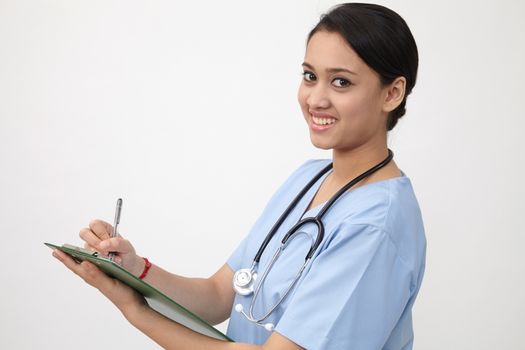 nurse writng on the clipboard that she is holding