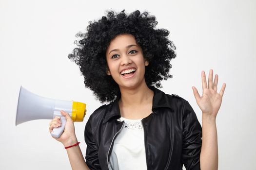 Indian teenage holding a megaphone on the white background