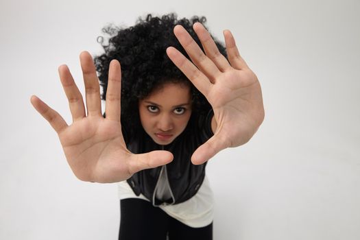 high angle ,indian girl with big afro hair with hand gesture