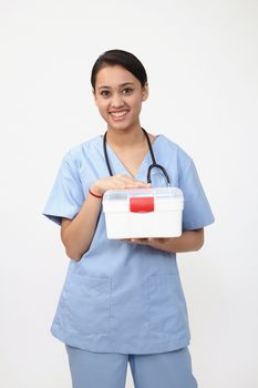 female nurse or doctor carrying a portable first aid kit isolated on white