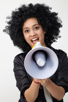 Indian teenage holding a megaphone on the white background