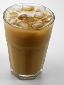 Ice coffee in a glass over gray background