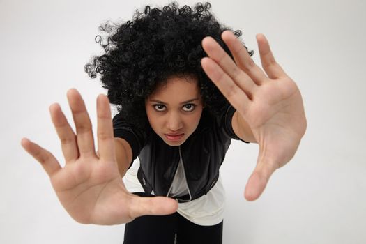 high angle ,indian girl with big afro hair with hand gesture