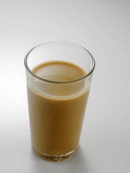 Ice coffee in a glass over gray background