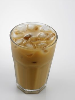 Ice coffee in a glass over gray background