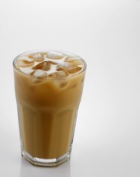 Ice coffee in a glass over gray background