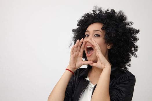 Happy girl with big afro hair shouting