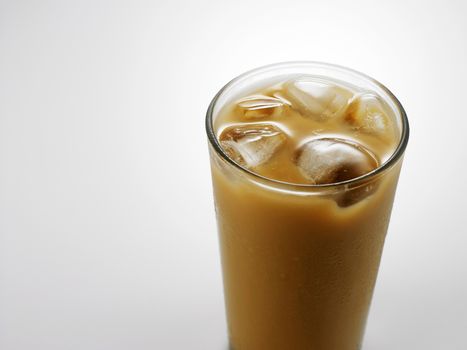 Ice coffee in a glass over gray background