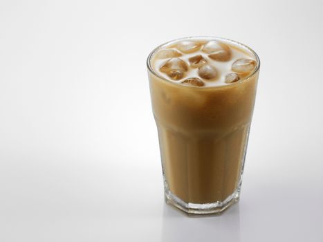 Ice coffee in a glass over gray background