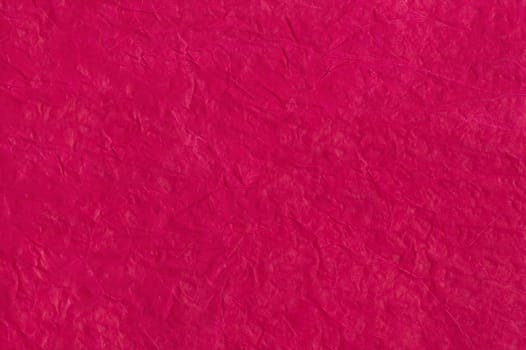 Bright crimson abstract background from crumpled paper. Crumpled paper texture. Paper wrinkles