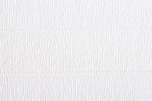 White corrugated paper. Crepe paper texture. White abstract paper background. Paper wrinkles, wavy surface