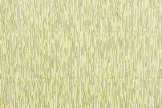 Light green corrugated paper. Crepe paper texture. Light green abstract paper background. Paper wrinkles, wavy surface
