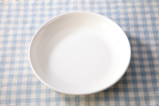 white plate isolated on table cloth