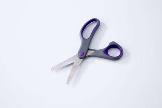 pair of scissors on the white background