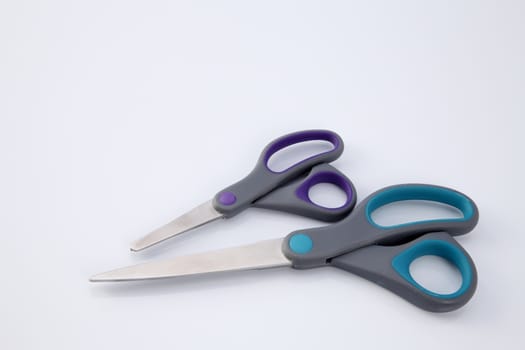 two pair of scissors which one big and small on the white background