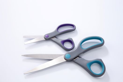 two pair of scissors which one big and small on the white background