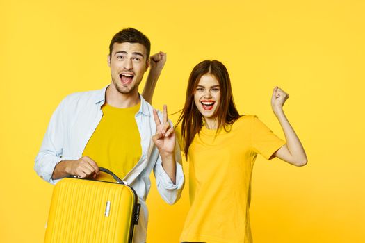 A happy man and his girlfriend go on a trip with a suitcase in their hands