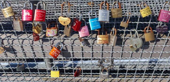 Many Love locks hanging at a pier at a baltic sea beach