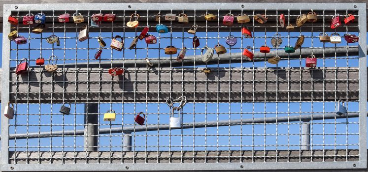 Many Love locks hanging at a pier at a baltic sea beach