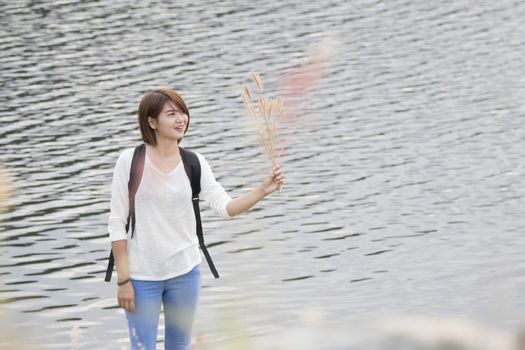 Young happy woman having fun outdoors with nature