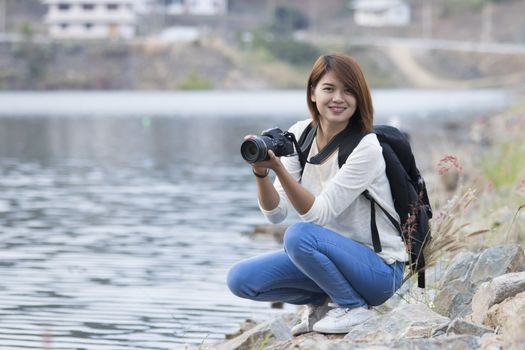 attractive young woman talking pictures outdoors,asian woman