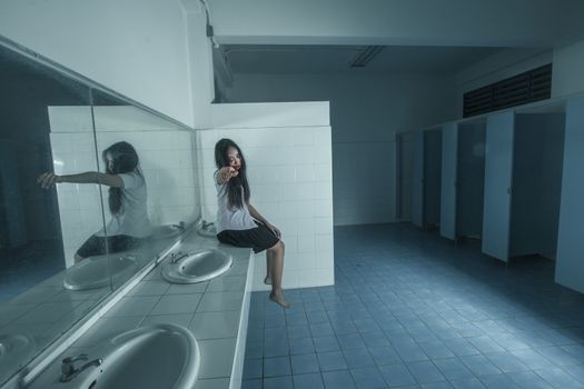 Ghost university girl sitting in restroom,Dark tone