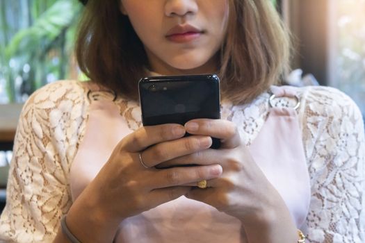 Woman hold with smart phone at coffee shop