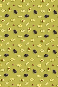 Avocado. Background made from isolated Avocado pieces on olive color background. Flat lay of fresh ripe avocados and avacado pieces