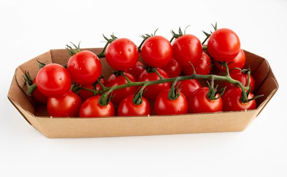 Cherry tomatoes on a branch in eco-friendly packing