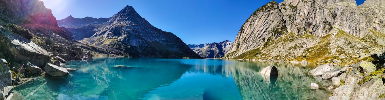 Gelmersee. Dam in the Swiss alps for Hydro power. Clear Blue lake with clear sky.