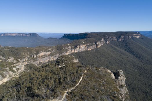 Mountain range and valley on a clear cloudless day in The Blue Mountains in New South Wales, Australia.