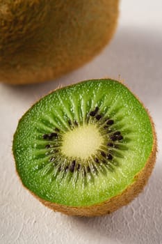 Kiwi fruits half sliced on white background, macro