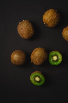 Kiwi fruits half sliced on dark background