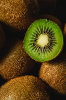 Kiwi fruit half sliced close up macro, healthy lifestyle and food, vibrant green color