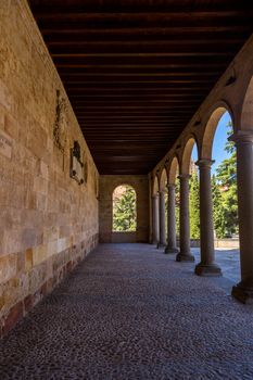 Salamanca, Spain - April, 28, 2019: Old historic cloister in the downtown of Salamanca. Plateresque XV century. The old city of Salamanca was declared a UNESCO World Heritage site in 1988.