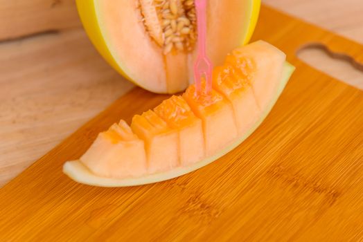 fresh golden melon on wood plate