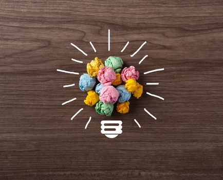 Creative idea, Inspiration, New idea and Innovation concept with Crumpled Paper light bulb on wooden background
