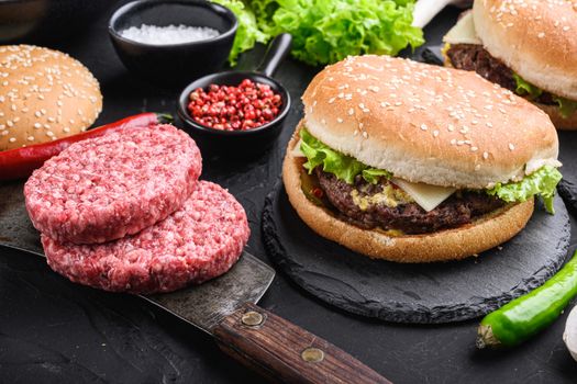 Ground beef steaks for home made burger on black textured background.