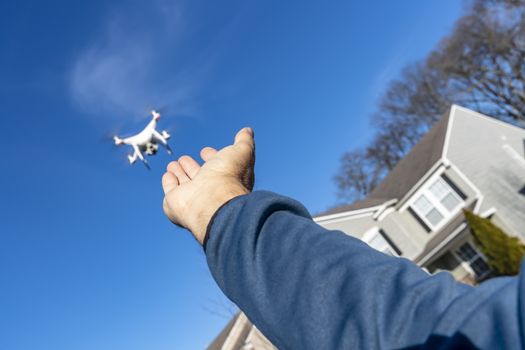 A group of drones fly through the air against a blue sky