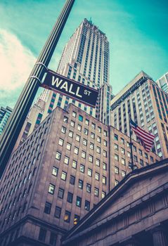 A Sign For Wall Street In Lower Manhattan, New York, With Skyscrapers Towering Behind