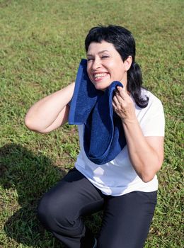 Sport and fitness. Senior sport. Active seniors. senior woman wiping out sweat after hard workout outdoors in the park