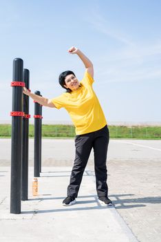 Sport and fitness. Senior sport. Active seniors. Senior woman doing stretching outdoors on the sports ground