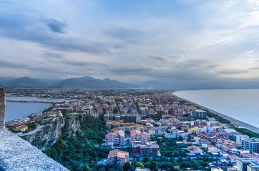 View of the city of milazzo isthmus and mountains background sicily