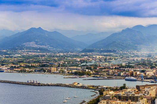 Port of milazzo moor the city and as background the sicilian mountains