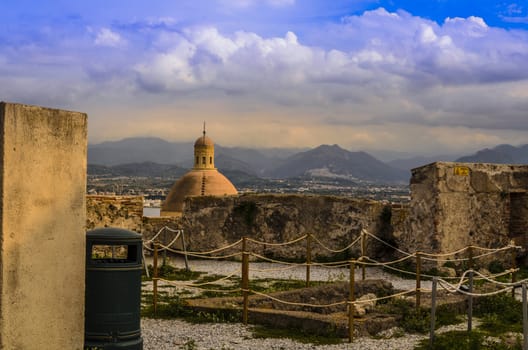 Mountainous landscape of sicily with church dome from the defenses of the norman castle of milazzo