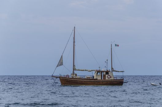 Sailboat sailing with its lifeboat on the Aeolian Islands tyrrhenian sea