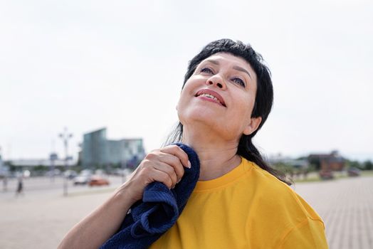 Sport and fitness. Senior sport. Active seniors. senior woman wiping out sweat after hard workout outdoors in the park