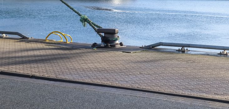 Different bollards and technical installations of vessel traffic at a port .